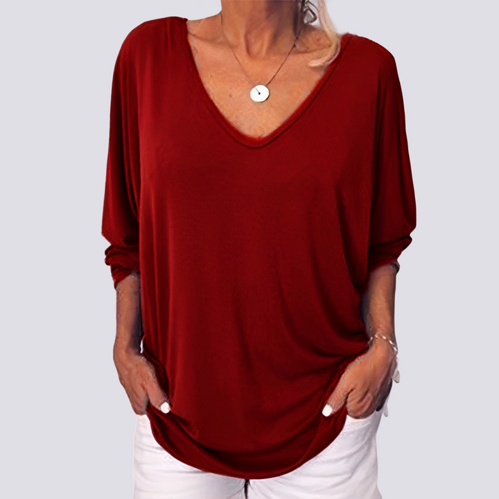 Top feminino moderno com detalhe abotoado nas costas. Combine com jeans para um look casual elegante.