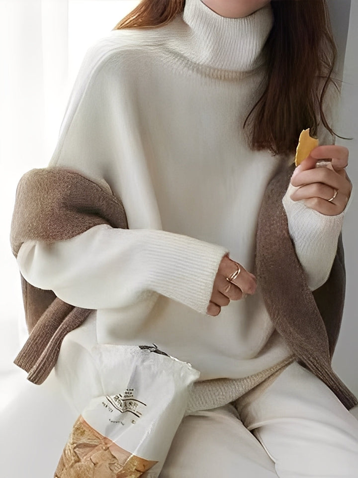 Suéter feminino elegante de malha cinza com gola alta, ideal para o inverno e outono. Caimento solto e confortável.