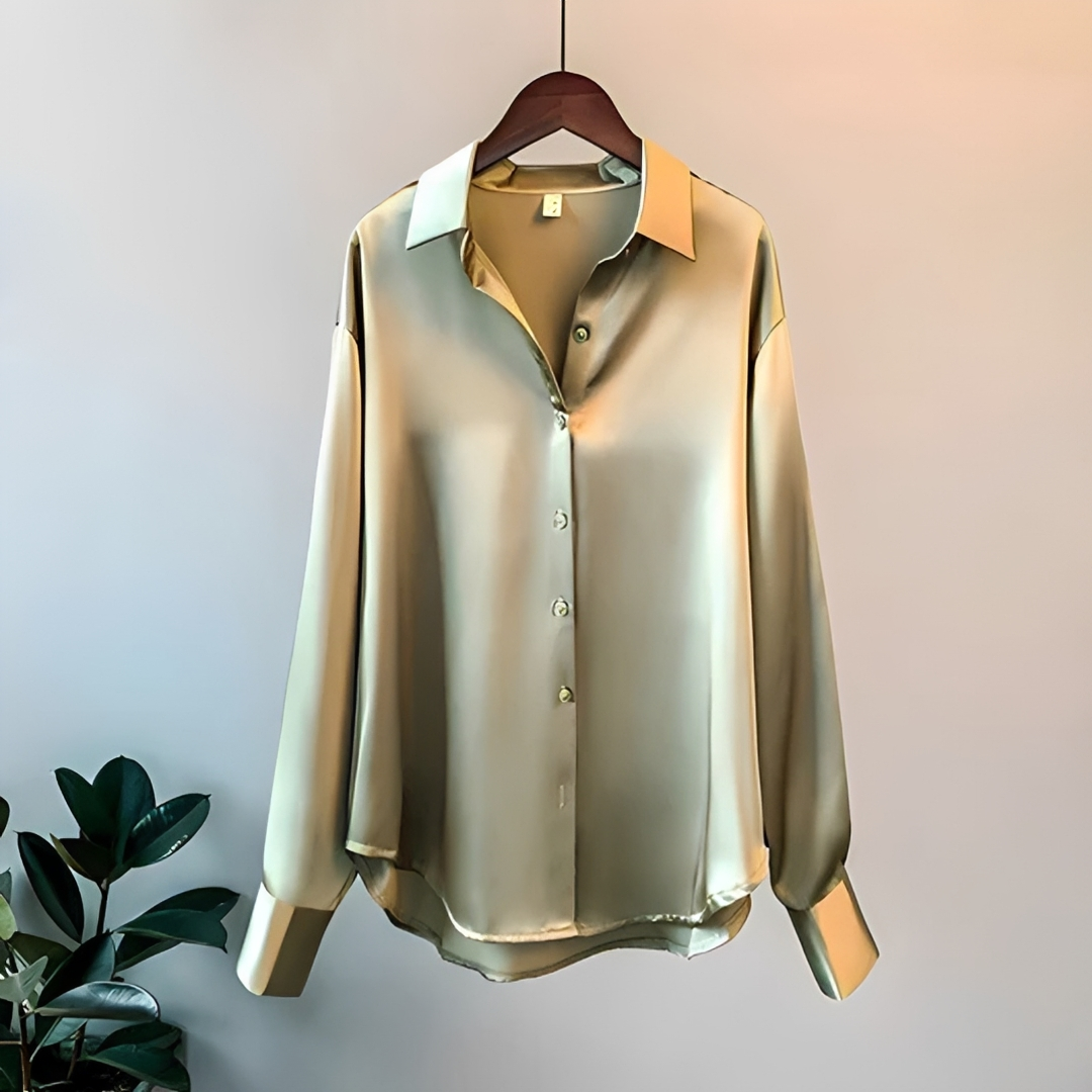 Camisa feminina versátil de manga longa e tecido brilhante, perfeita para vestuário casual e social.
