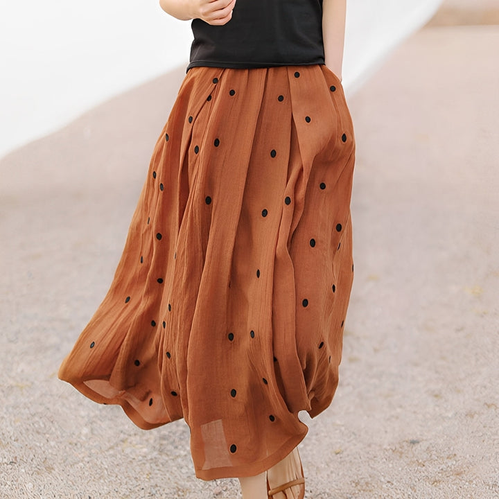 Saia feminina Thea casual de bolinhas, perfeita para o verão. Estilo elegante e moda retrô chic para o dia a dia.