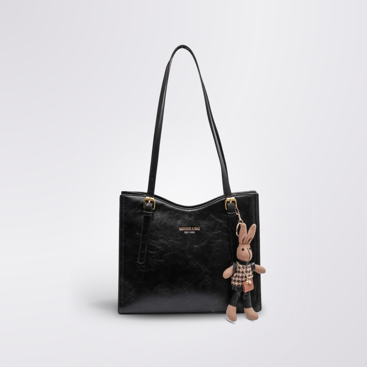Interior da Bolsa Lena, compartimento prático para laptop, couro vegano, acessório feminino durável.