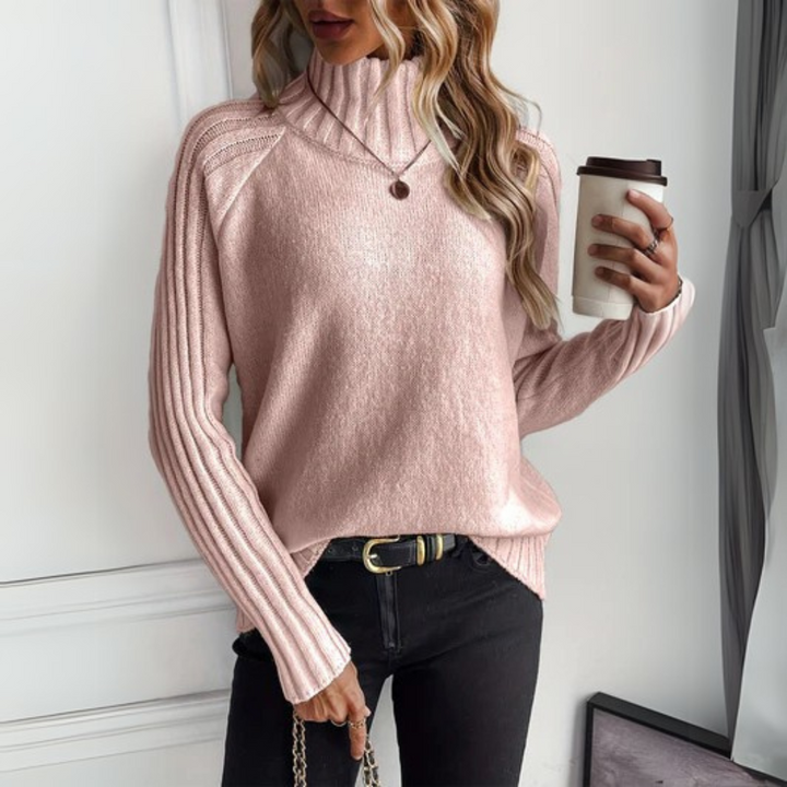 Suéter de tricô feminino em malha suave, ideal para dias frios. Peça elegante e moderna que oferece conforto.