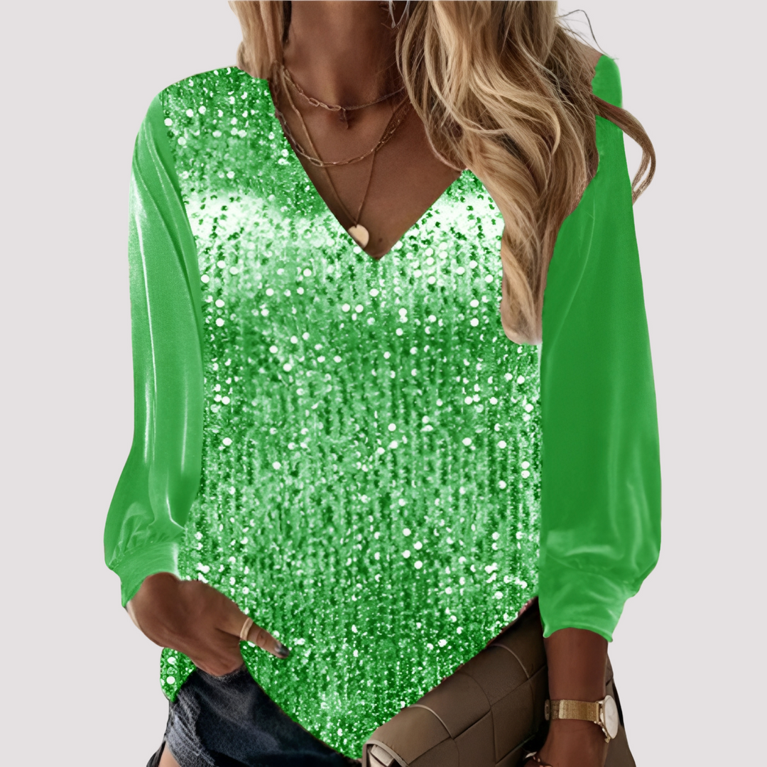 Blusa feminina de manga longa com lantejoulas brilhantes, perfeita para festas e looks noturnos elegantes.