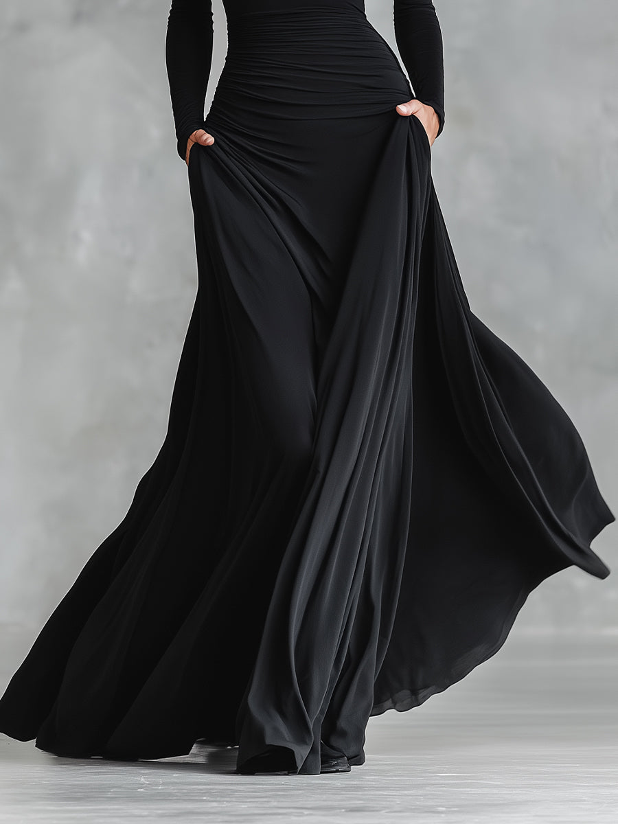 Vestido feminino preto sofisticado, estilo maxi, com detalhes de pregas fluidas, para eventos de gala.