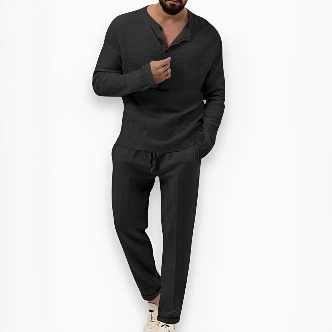 Homem vestindo conjunto masculino de verão casual, com top e calças leves, para um dia de férias.