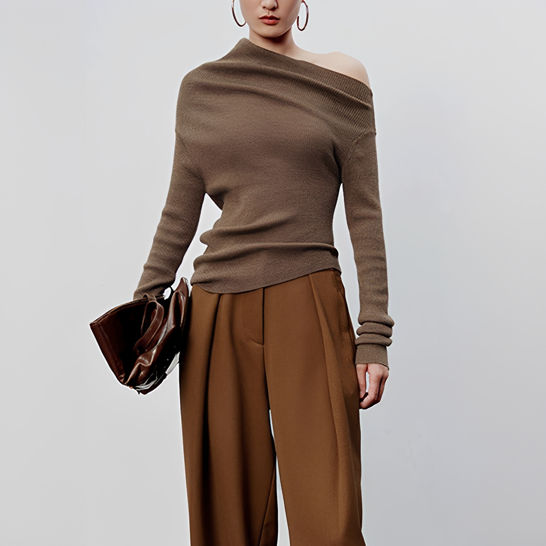 Top feminino assimétrico de manga longa, estilo moderno e elegante, ideal para looks casuais e sofisticados.