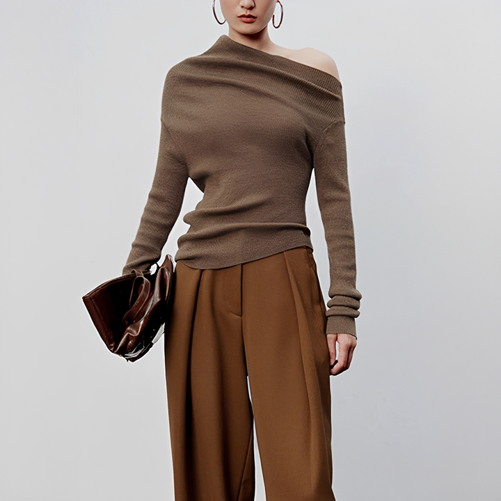 Top feminino assimétrico de manga longa, estilo moderno e elegante, ideal para looks casuais e sofisticados.