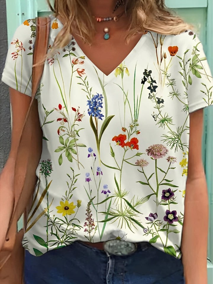 Top feminino floral vibrante, estilo leve e confortável. T-shirt elegante para verão e primavera, moda casual mulher.