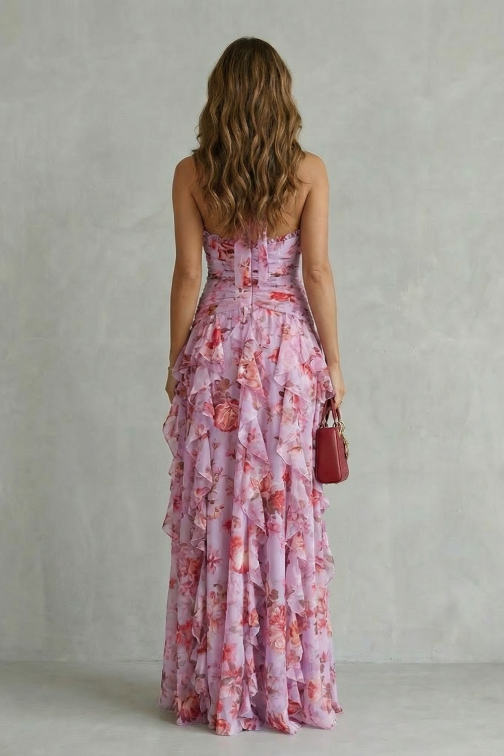 Detalhe da estampa de rosas vermelhas e folhas verdes em tecido leve de vestido feminino romântico.