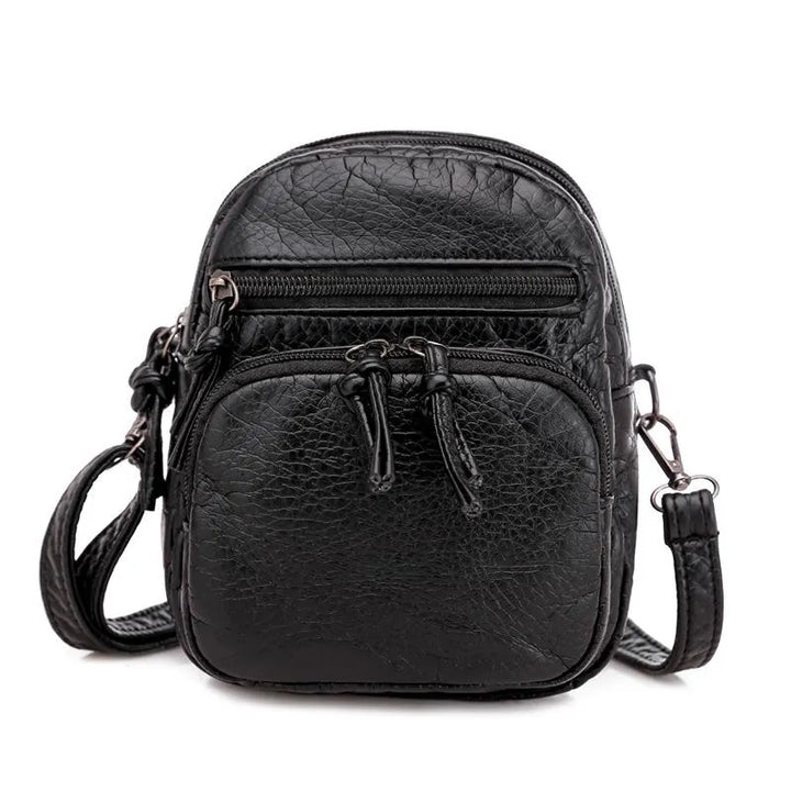 Mala de ombro de pele macia preta, design feminino e casual para conforto e elegância.