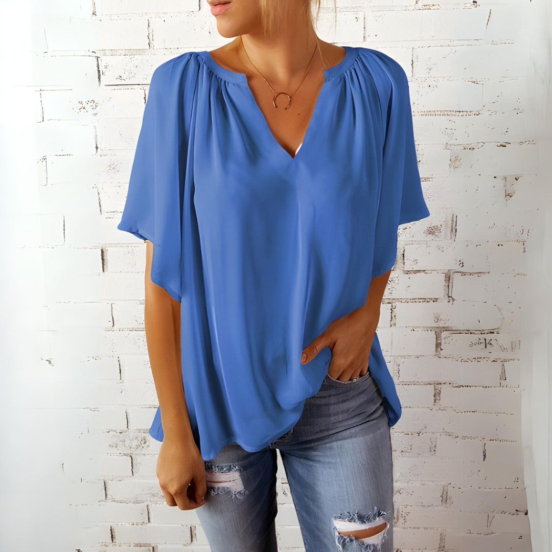 Blusa feminina elegante com decote V e mangas fluidas, ideal para primavera e verão.