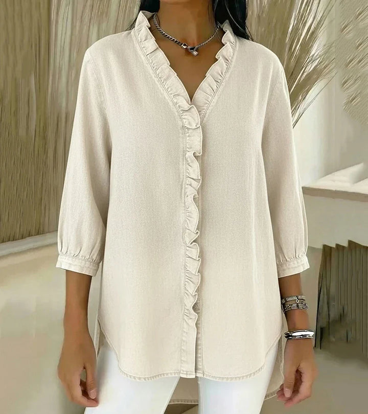 Blusa feminina com decote V profundo e delicado volante na barra, estilo casual chic e confortável.