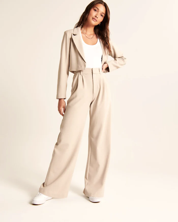 Calça feminina bege de alfaiataria, corte perna larga moderno para estilo e conforto.