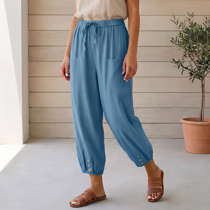 Calça feminina ampla de cintura alta. Peça elegante para moda casual. Versátil e confortável para o verão.