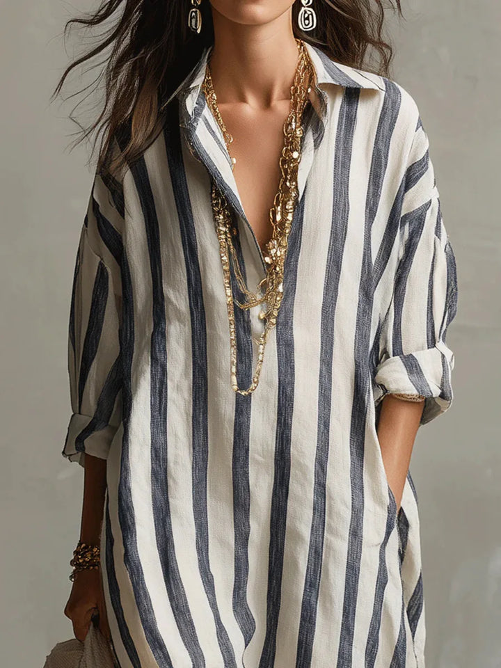 Vestido camisero feminino de estilo descontraído. Manga três quartos e decote V, ideal para o conforto no verão.