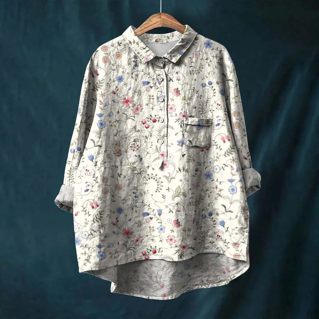 Camisa feminina floral leve, com mangas longas. Ideal para o verão, proporcionando elegância, frescor e conforto.