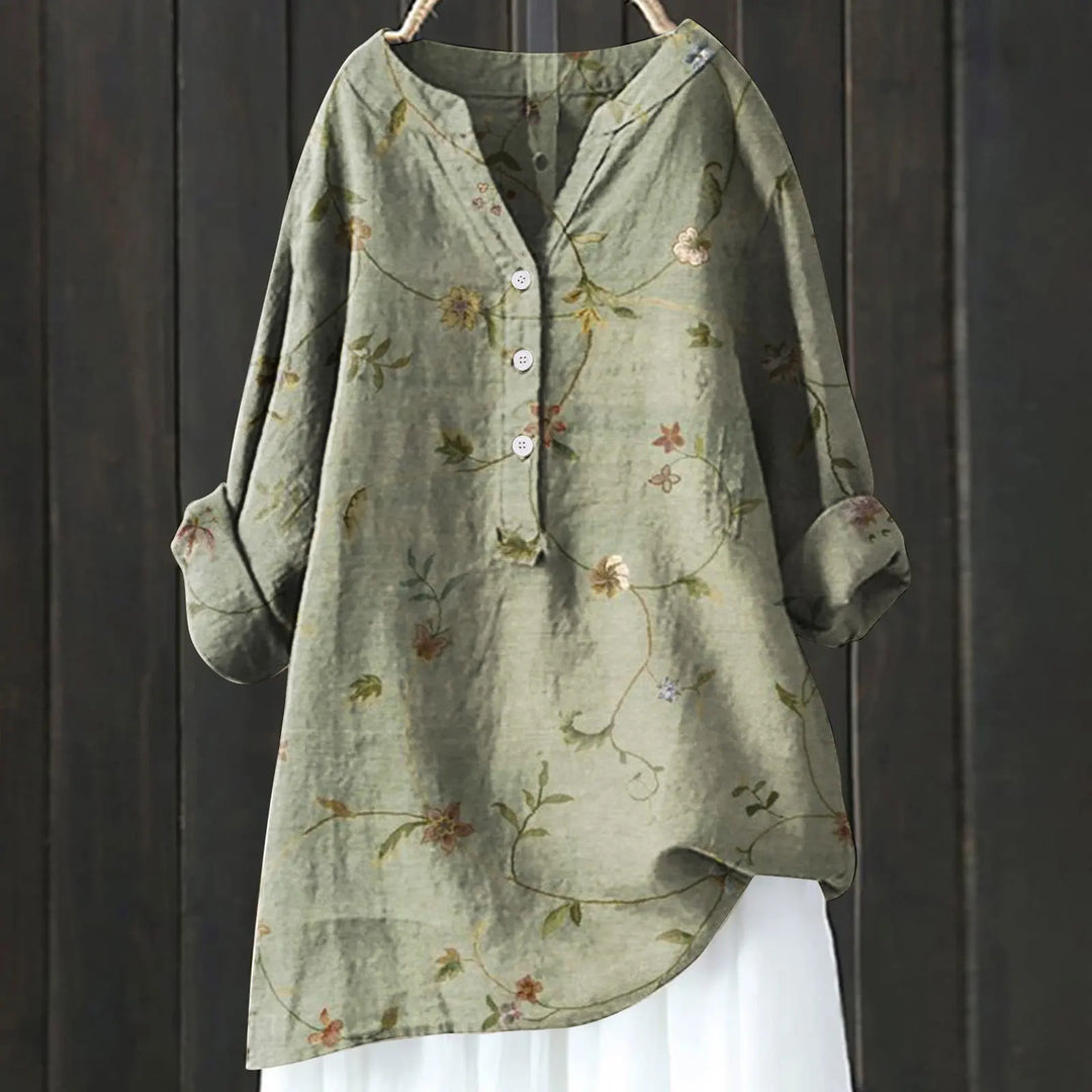 Blusa floral feminina com estampa de cores vibrantes, ideal para passeios e eventos de verão.