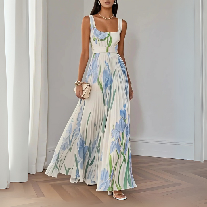 Vestido longo plissado com estampa floral delicada. Peça feminina elegante para eventos de verão.
