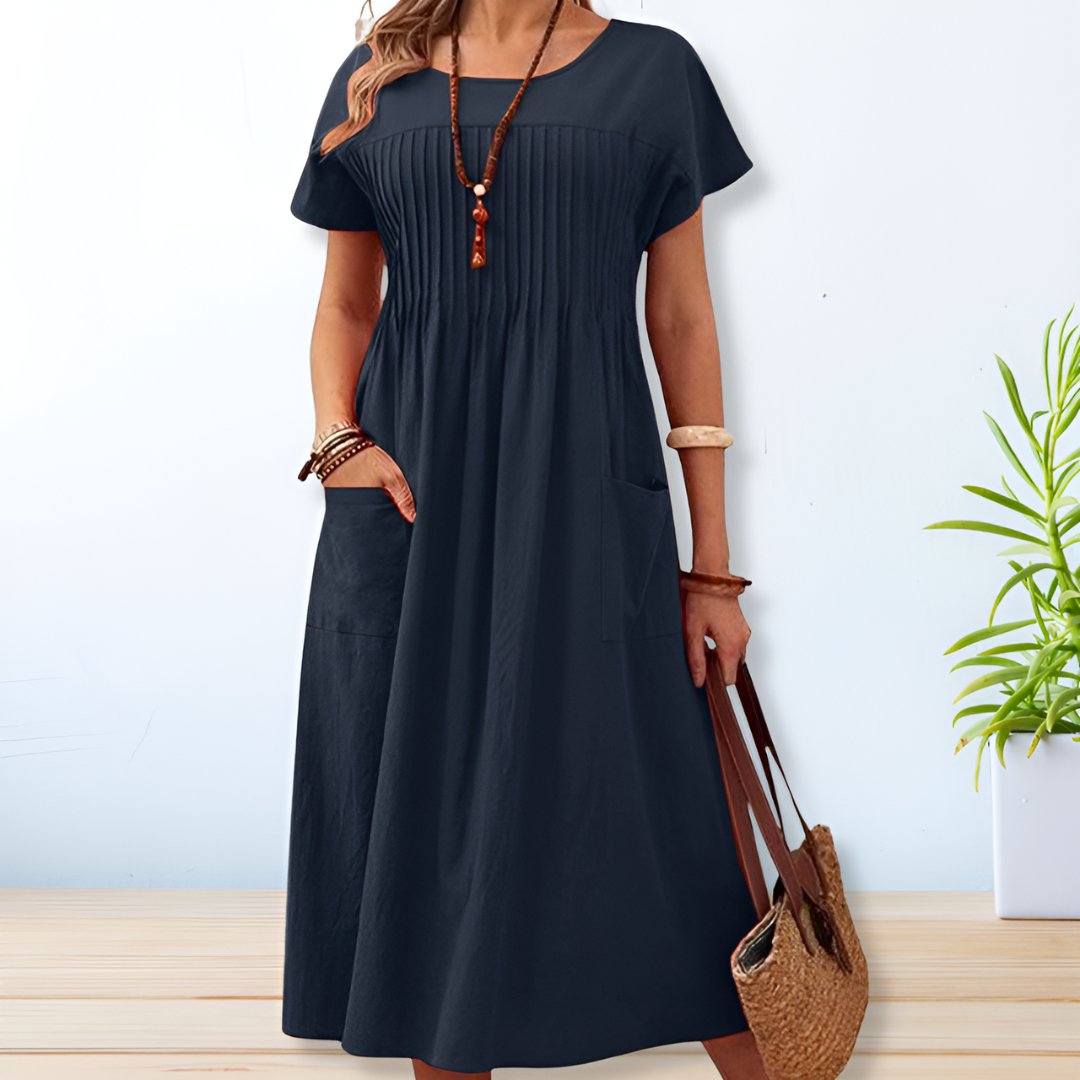 Vestido feminino Leona midi com bolsos, ideal para o dia a dia. Conforto e estilo relaxado em cores vibrantes para o verão.