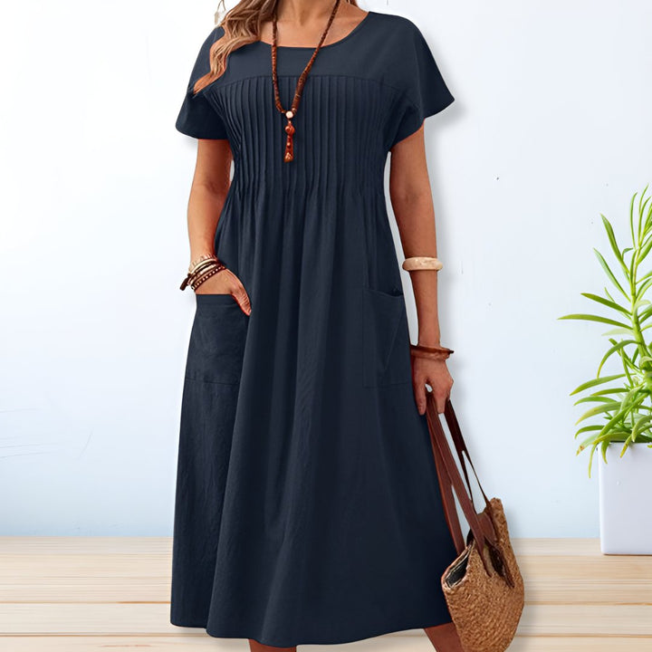 Vestido feminino Leona midi com bolsos, ideal para o dia a dia. Conforto e estilo relaxado em cores vibrantes para o verão.