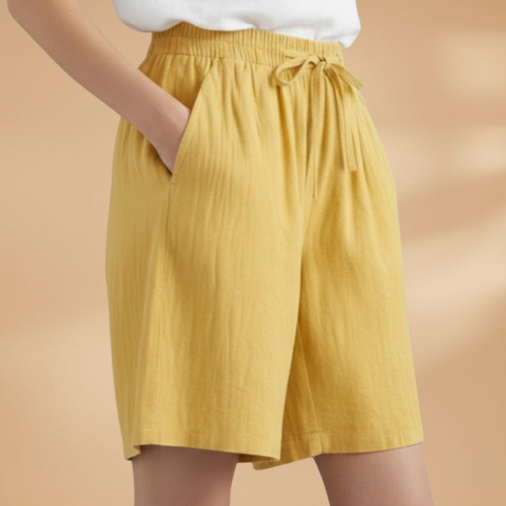 Moda verão: Bermudas femininas confortáveis até ao joelho, cintura elástica.