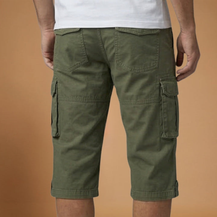 Homem a usar calções cargo com bolsos laterais, mostrando o conforto e o ajuste. Ideal para look de verão casual.
