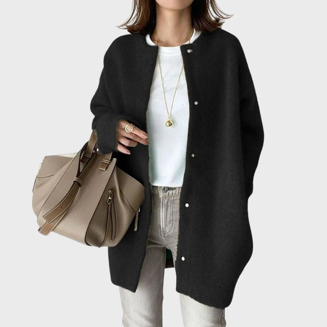 Mulher a usar casaco de malha oversized bege com botões, comfy e estiloso para moda de inverno.