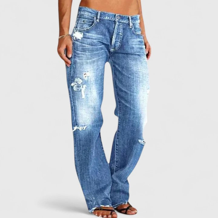 Jeans femininos rasgados de cintura baixa, corte largo, estilo streetwear. Perfeitos para um look casual e moderno.