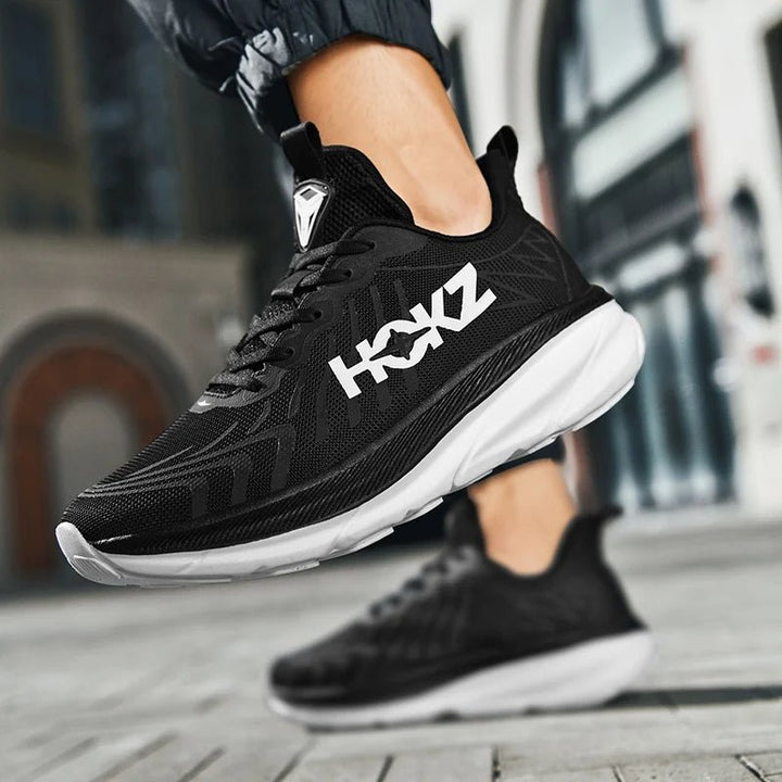 Detalhe frontal do sapato masculino Calum V2, design moderno e conforto para corrida e lazer.