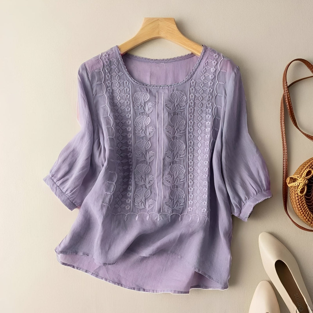 Modelo de blusa feminina casual solta, disponível em várias cores, destacando o bordado elegante. Confortável.