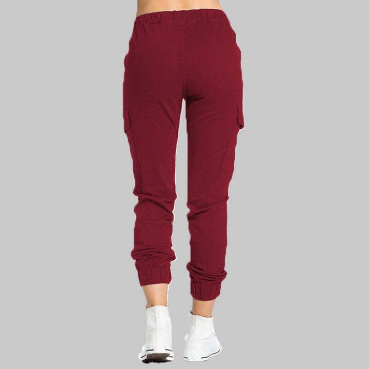 Calças cargo femininas, cintura elástica, bolsos, para um visual streetwear elegante e confortável no dia a dia.