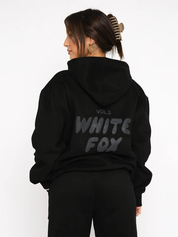 Roupa feminina: conjunto de fato de treino oversized com capuz e calças, para conforto e estilo casual.
