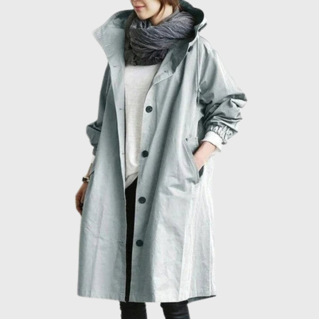 Casaco gabardina feminino comprido, impermeável, com capuz e corte largo, ideal para outono/inverno. Conforto e moda.