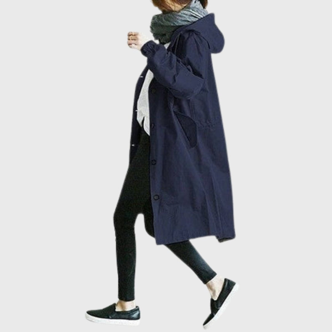 Mantenha-se seca e chique com esta gabardina comprida impermeável de corte largo e capuz para mulher. Perfeita proteção.
