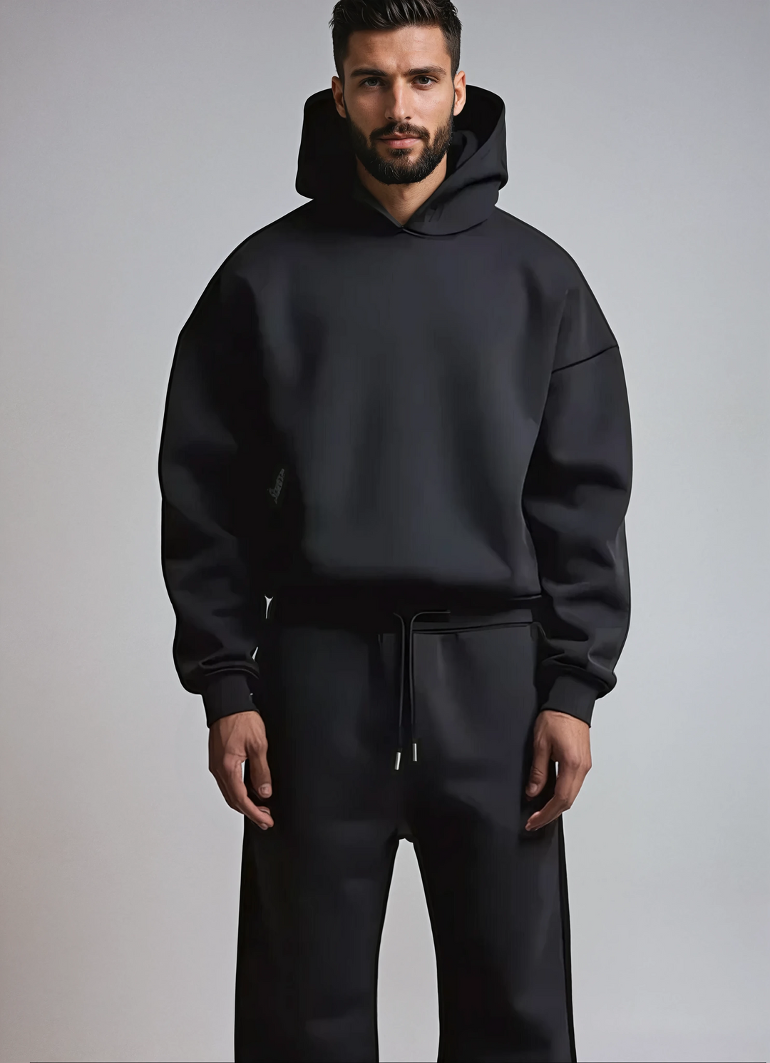 Conjunto desportivo masculino oversize macio, com capuz e calças, perfeito para relaxar ou streetwear.