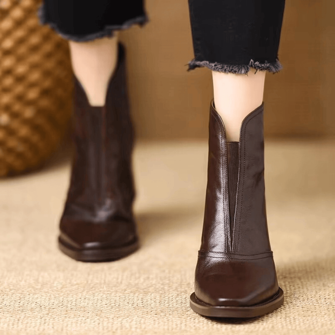 Detalhe do tacão médio em botins femininos, garantindo conforto e estilo para calçado de inverno.
