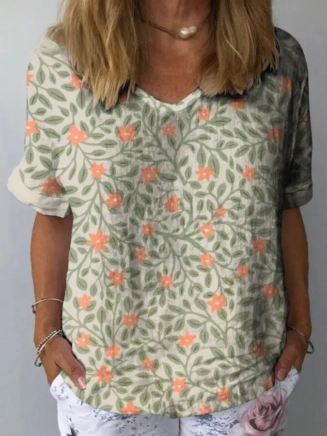 Camisa feminina casual de manga curta com estampa floral artística verde claro, ideal para o verão e moda com conforto.